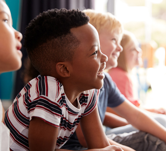 smiling children watching together three friends engaging in joyful learning